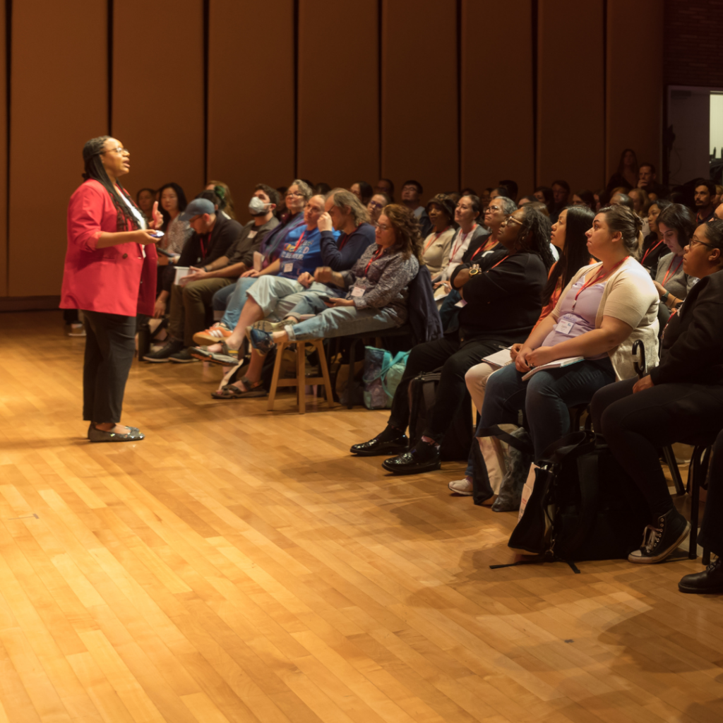 Ashley Cuthbertson speaking to a group of music and arts teachers during a keynote on culturally responsive music teaching.